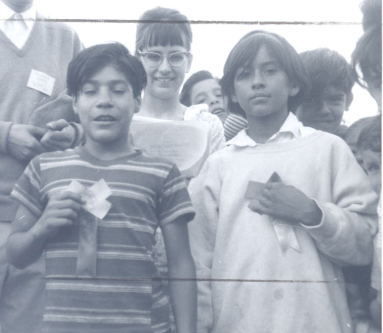 Children of migrant workers win a sack race.